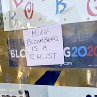 Mike Bloomberg a 'racist' and 'sexual predator,' according to signs stuck to his Florida campaign office windows