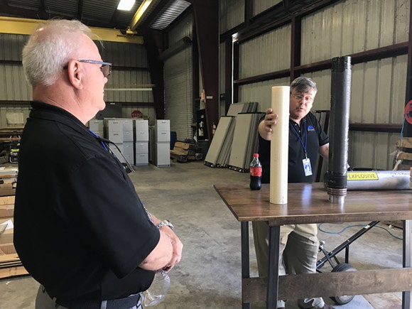 VP of Propulsion Robert Fabian (right) and Chief Technologist Ron Jones (left) present two cylinders of 3D-printed rocket fuel during a media tour on Monday, May 7 at Rocket Crafters' Cocoa Beach manufacturing facility. - Photo by Joey Roulette