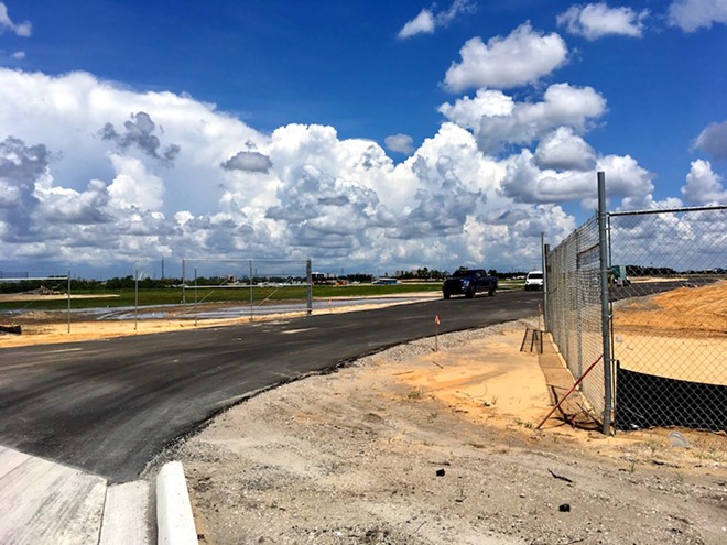 The new paved road is believed to provide access for grading and eventually construction on the expansion land. The entrance is off Destination Parkway near UCF's Rosen College of Hospitality. - photo by Paul Brinkmann
