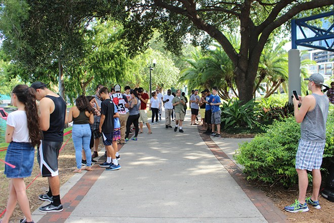 Players wait for a rare Pokémon to respawn in Lake Eola Park..