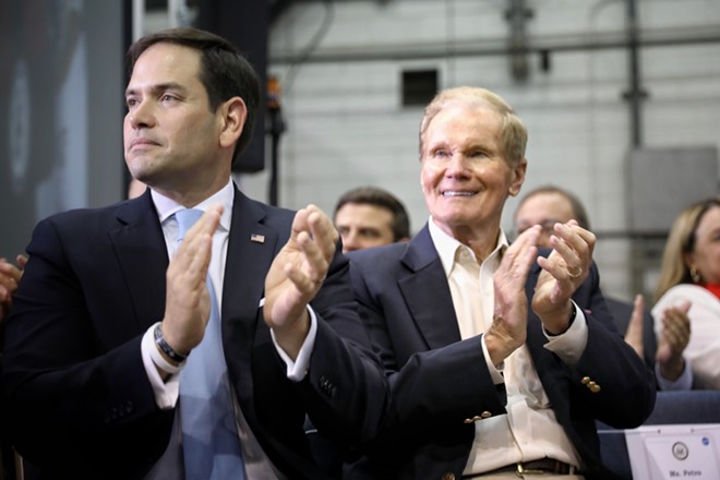 Sens. Bill Nelson and Marco Rubio applaud during a speech from Vice President Mike Pence at the Kennedy Space Center, Florida in 2017. - PHOTO BY JOEY ROULETTE