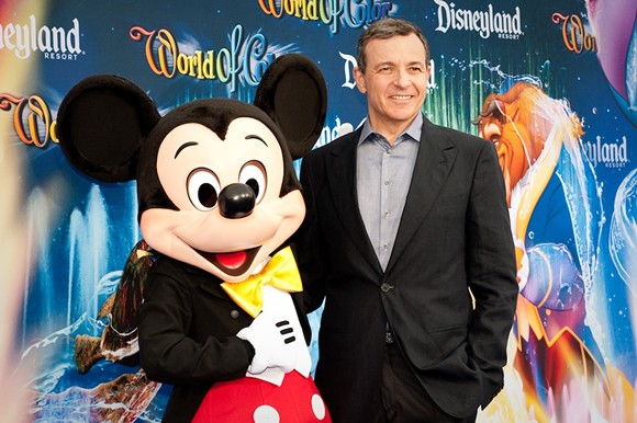 Disney CEO Bob Iger with a Disney employee in costume - Photo via Wikimedia