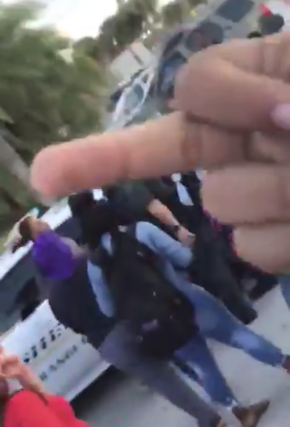 The woman recording the incident took a moment to say "fuck 12" and flip them off. Also, note the backpacks in the video. - Photo via Rasha MK Twitter screengrab @RashaMK