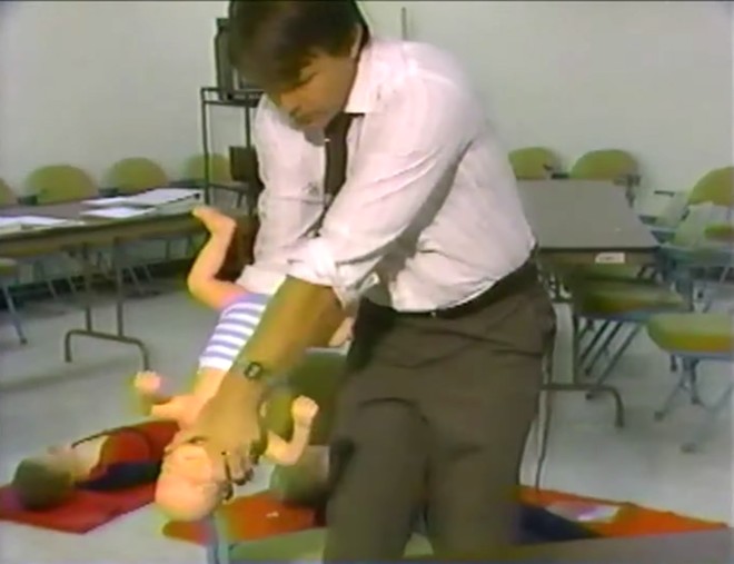 Sam Dick demonstrates how not to save a choking baby - SCREENSHOT OF WESH VIA TELEVISIONARCHIVES/YOUTUBE