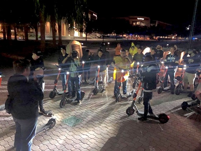 Dozens of UCF students gather every Friday night at 9 p.m. to ride around campus as "Spin Squad," a social group that formed recently due to the new scooters on campus. - Lillian M. Hernández Caraballo