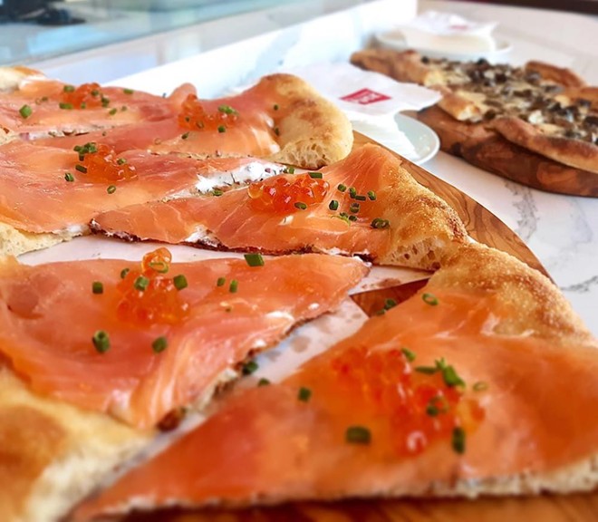 Smoked Salmon pizza with dill cream, chives and salmon pearls - Photo via Wolfgang Puck Bar & Grill Orlando/Facebook