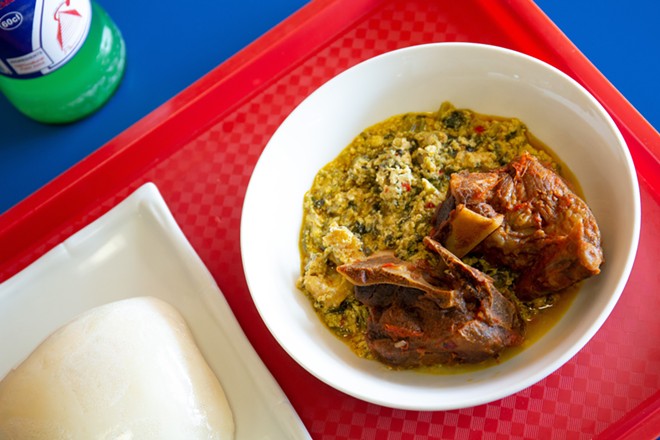 Egusi (goat pepper soup) with pounded yam - Photo by Rob Bartlett