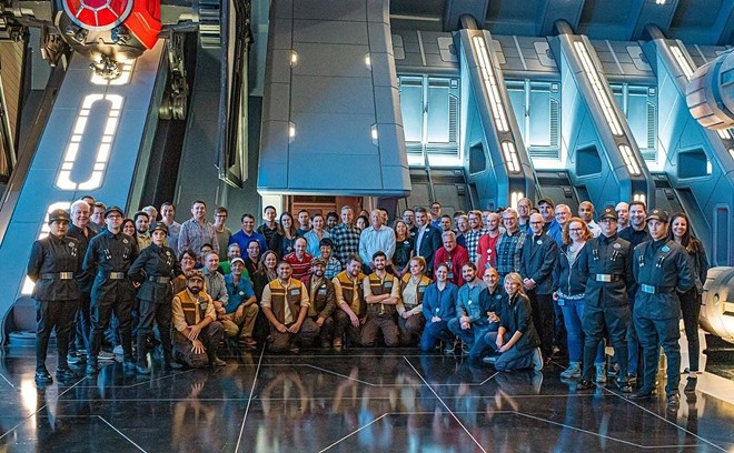 Disney Parks Chairman Josh D'Amaro shared a photo on Instagram of Disney Cast and Imagineers that worked to open DHS's Rise of the Resistance Star Wars-themed ride. Many fans noted the lack of obvious racial diversity within the photo. - Image via Josh D'Amaro | Instagram