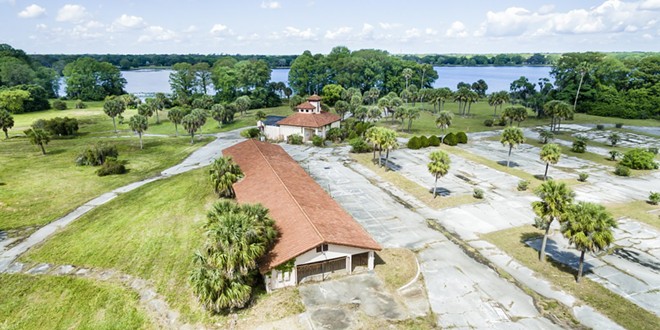 The current state of the former Lake Orlando Golf Club abandoned clubhouse. As seen immediately post-acquisition with Lake Orlando in the background. - Image via LakeOrlando.com