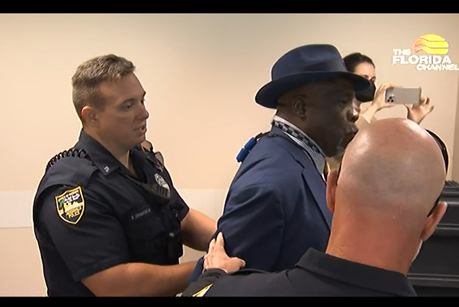 Ben Frazier, a Jacksonville activist, was handcuffed Jan. 4, 2022 before a press conference hosted by Gov. Ron DeSantis. - FLORIDA CHANNEL/SCREENSHOT