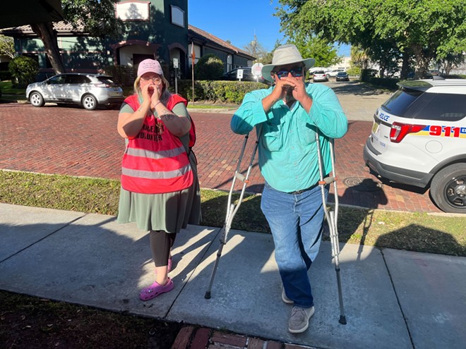 Volunteer with SWAN (left) mocks "yell" of anti-abortion protestor John (right) outside of Orlando abortion clinic. - SWAN