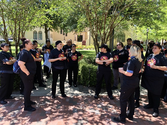 Barbara Penaroque (right), a senior supervisor for Sodexo at Rollins College, speaks to a group of workers at a "No Union" rally organized on campus in Winter Park, Florida. - McKenna Schueler