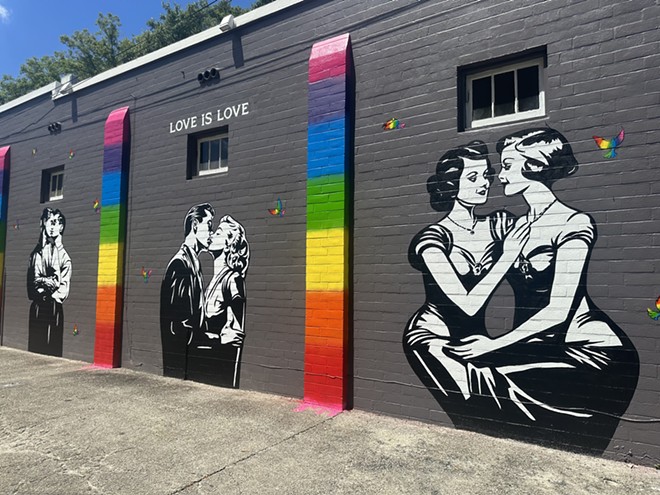 Corie Mattie/LA Hope Dealer finishes a "Love Is Love'" mural in Orlando's Thornton Park neighborhood. Aug. 2023. - Corie Mattie