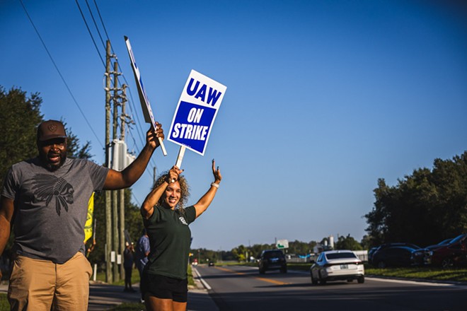 Kalilah Austin (right) stands next to co-worker Alex (left) on the picket line outside a Stellantis parts center in Orlando. - Photo by Dave Decker