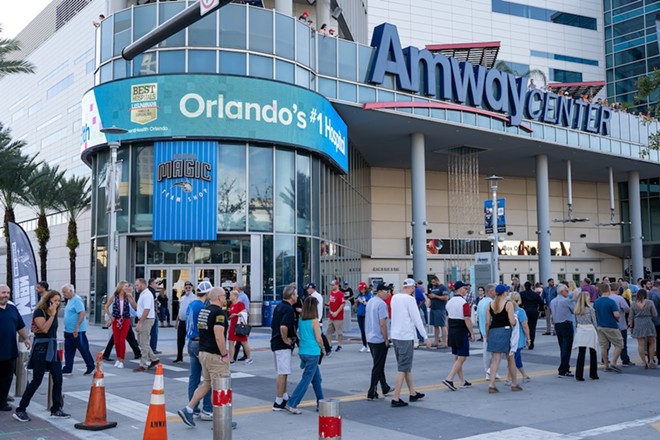 Patrons mill in front of the Amway Center in downtown Orlando. - Red Lemon/Shutterstock