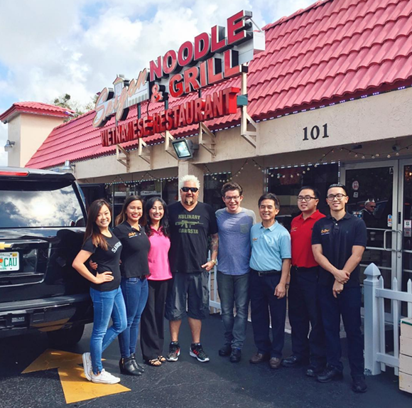 The Nguyen family, owners of Saigon Noodle & Grill, poses for a pic with Fieri after taping the show. - Photo courtesy @saigonnoodleandgrill on Instagram