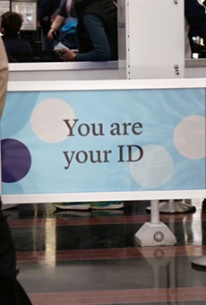 A railing with a facial recognition company's branding reads "You are your ID" at the Ronald Regan International Airport in Washington D.C.