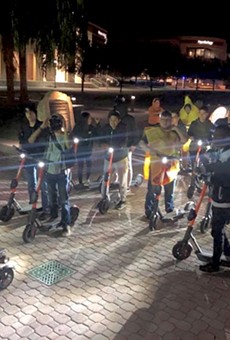 Dozens of UCF students gather every Friday night at 9 p.m. to ride around campus as "Spin Squad," a social group that formed recently due to the new scooters on campus.