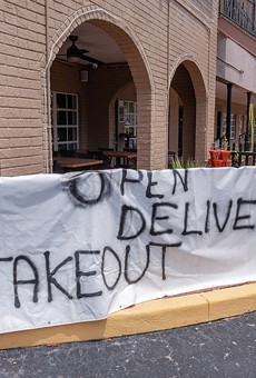 Sign on a Florida restaurant advertising takeout during coronavirus stay-at-home order