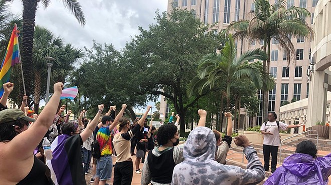 LGBTQ+ activists and allies rally in support of transgender rights outside Orlando City Hall on April 24, 2023.