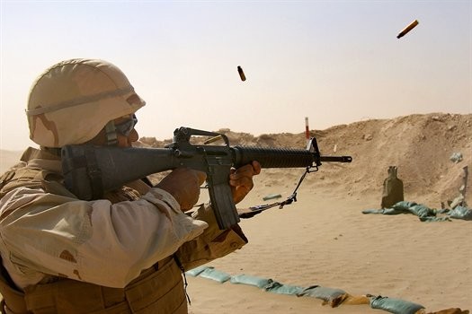 U.S. Navy Petty Officer 2nd Class Jason Maxwell fires an M-16 using a three-round burst at the Joe Foss range during a weapons training in Taqaddum, Iraq, July 27, 2008. The Seabees, assigned to a mobile construction battalion, are on a six-month deployment to Iraq to provide general engineering support to coalition forces. U.S. Navy photo by Petty Officer 2nd Class Dustin Coveny, via defense.gov