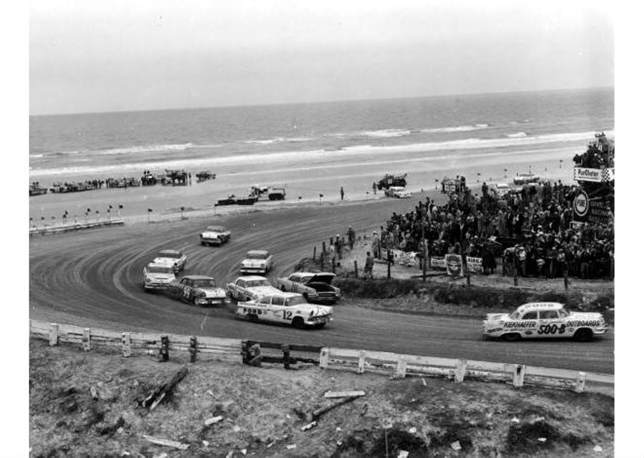 Automobiles racing on the beach road