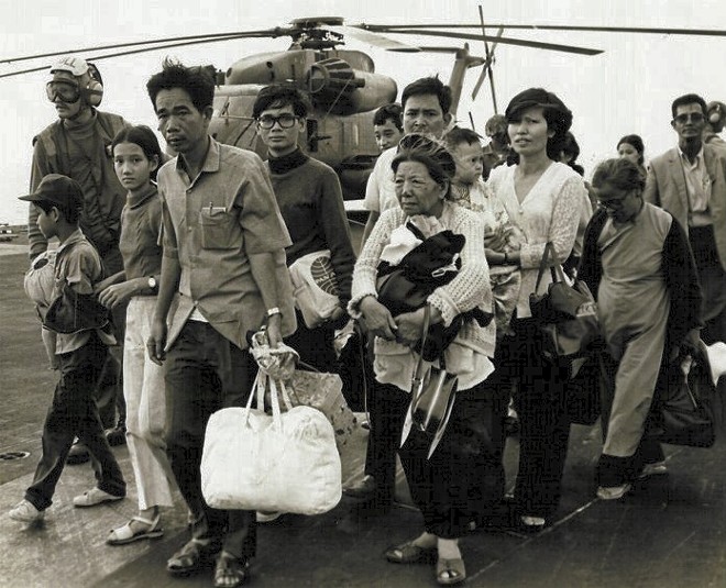 South Vietnamese refugees walk across a U.S. Navy vessel. Operation Frequent Wind, the final operation in Saigon, began April 29, 1975. During a nearly constant barrage of explosions, the Marines loaded American and Vietnamese civilians, who feared for their lives, onto helicopters that brought them to waiting aircraft carriers. - PUBLIC DOMAIN