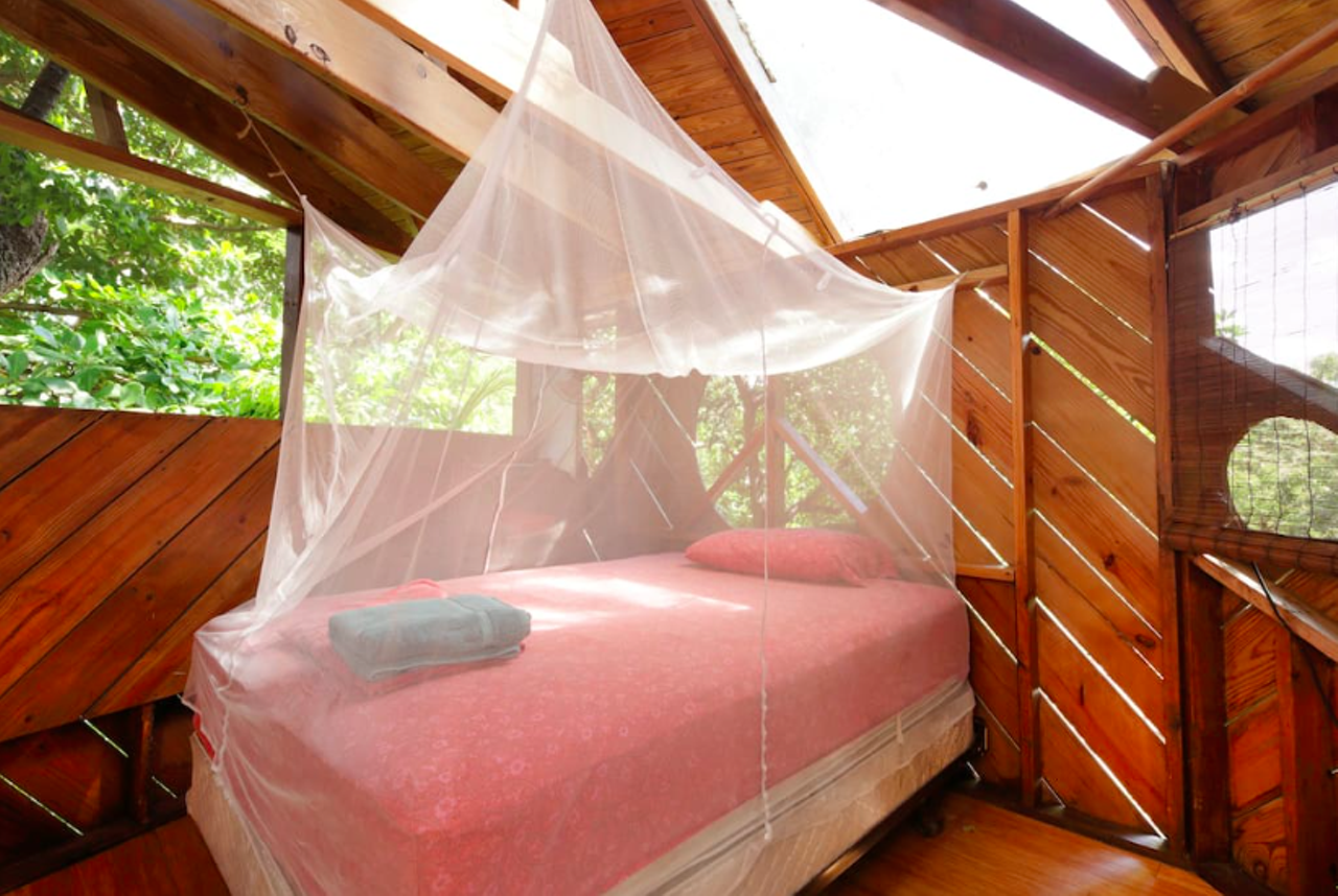 Here's the (pretty romantic) bed among the treetops in the Canopy Room.
image via Airbnb listing